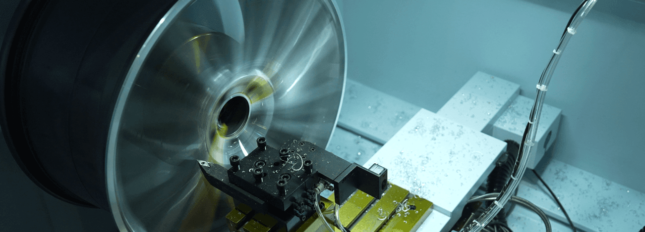 Modern indoor space with large glass doors, lush greenery, and a cozy seating area visible beyond.