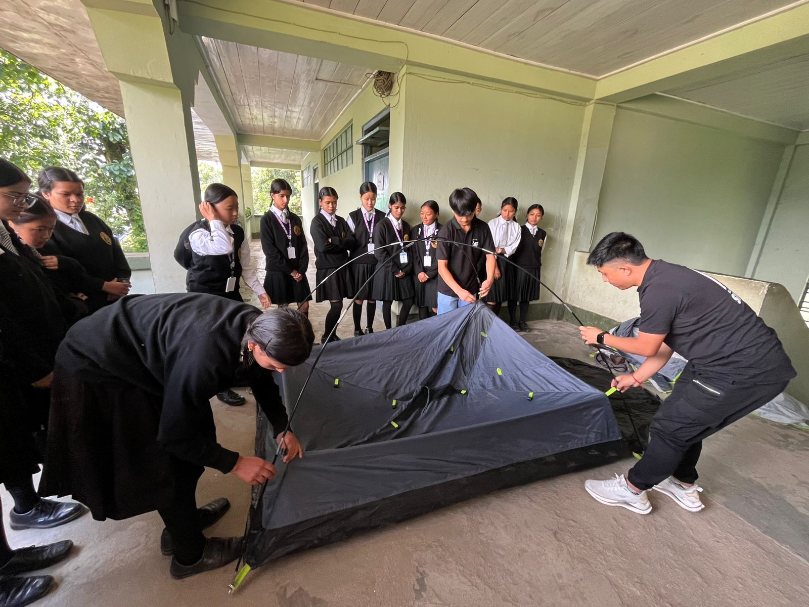 group of women in red and white dress standing on brown wooden bar during daytime