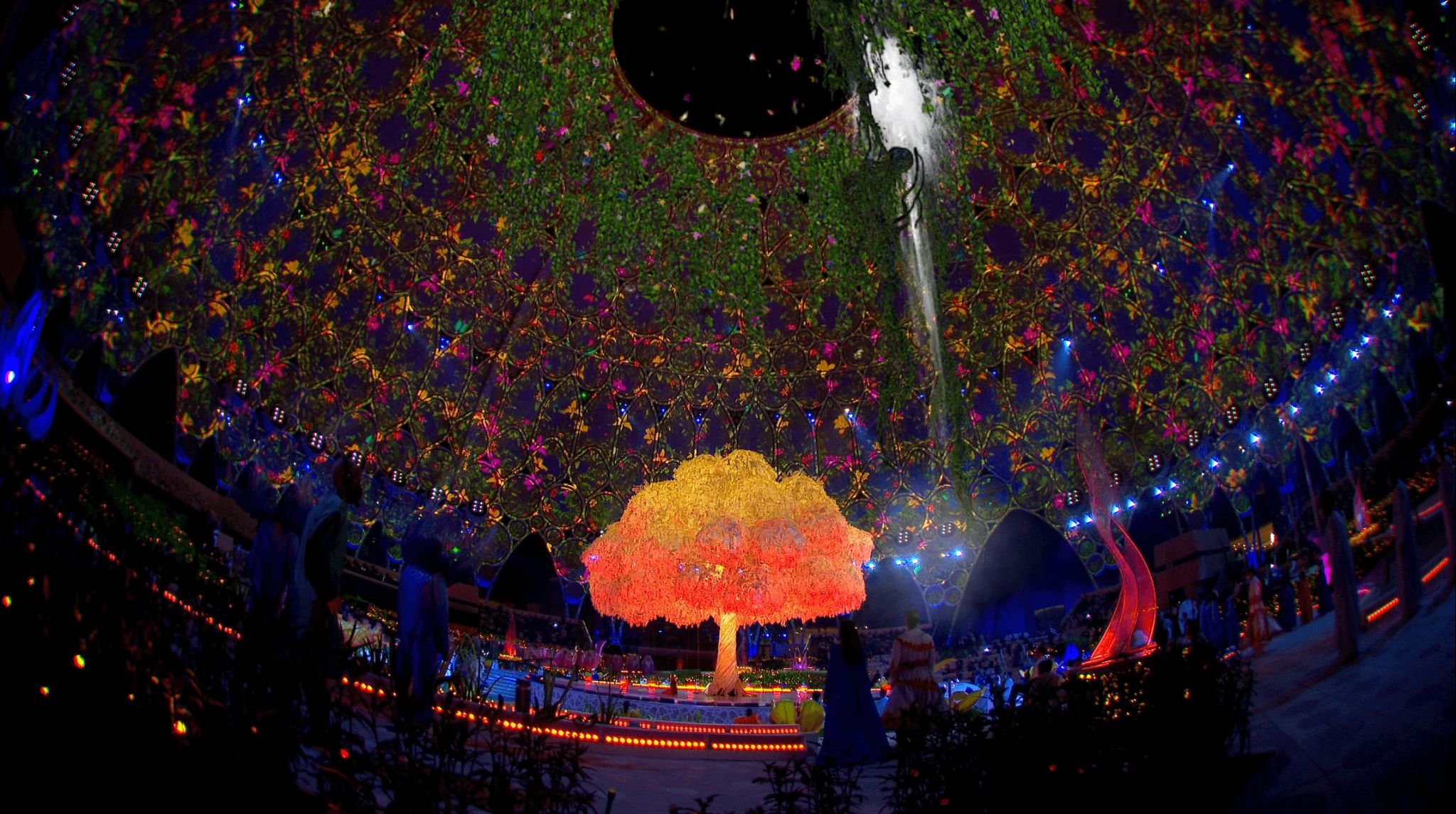 Andrea Bocelli performs under a beautiful tree in an immerisve garden scene layered with projection and AR 