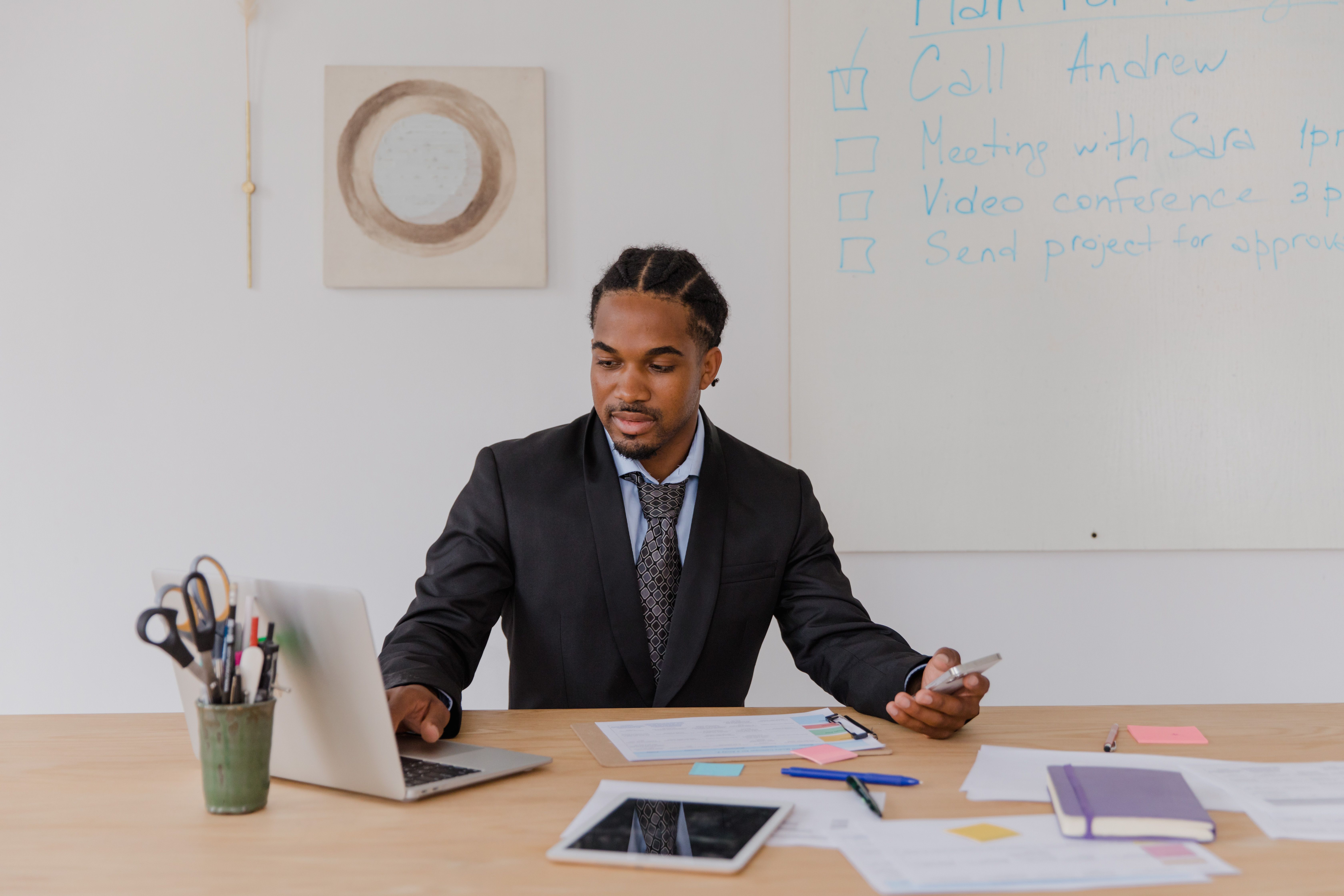 professional-businessman-working-at-desk-with-laptop-and-documents-in-modern-off - rdne-stock-project (pexels)
