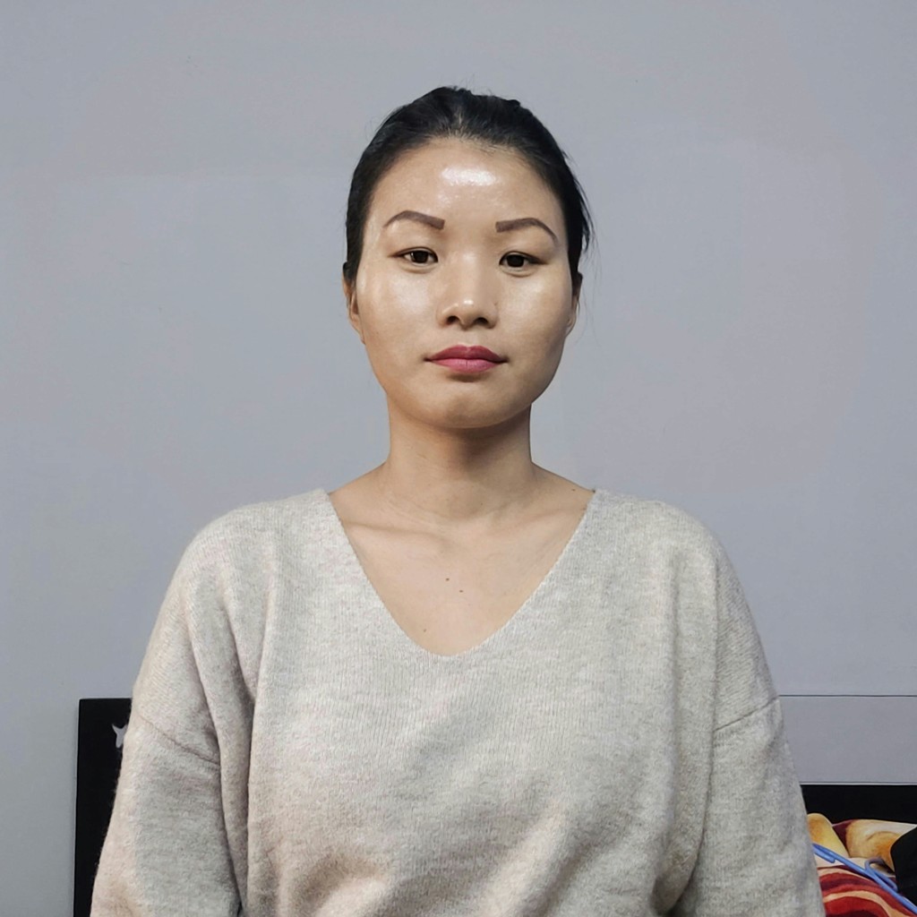 A woman standing in front of a painting