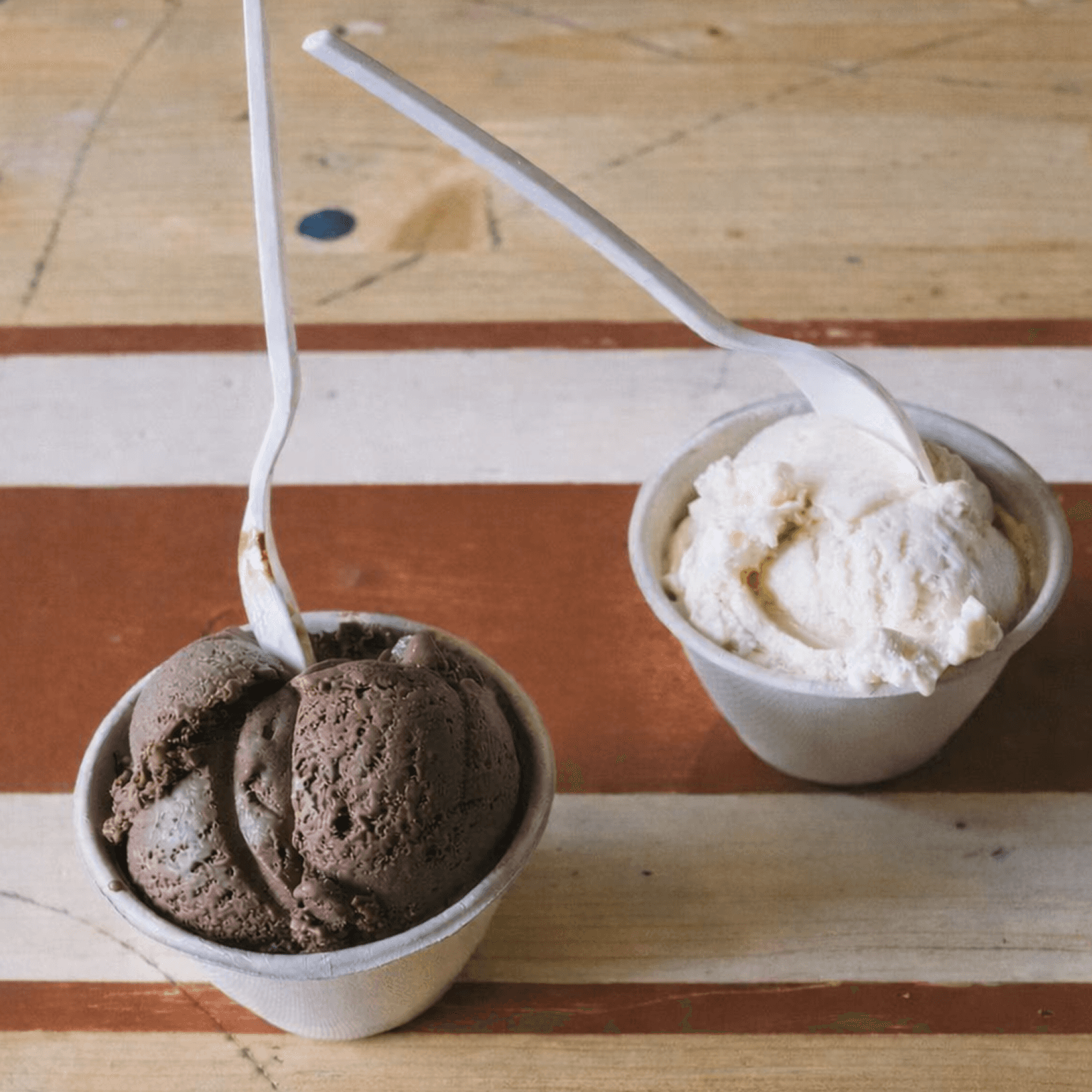 Tall, open restaurant venue with wood tables and chairs