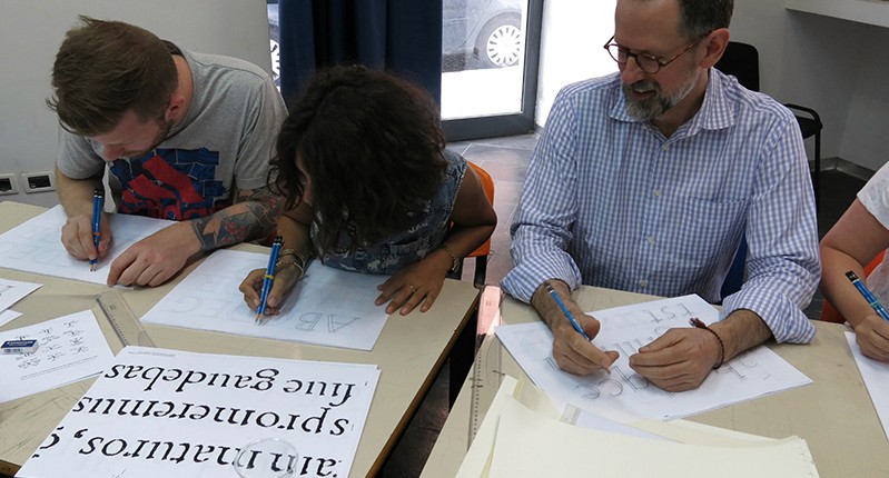 students practicing writing letters