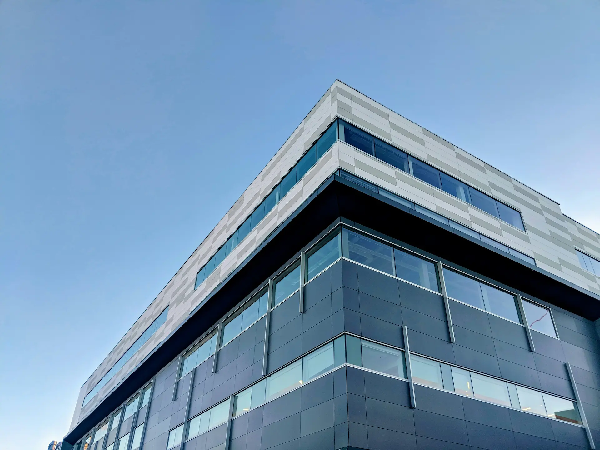 Modern multi-story glass office building representing professional commercial cleaning and facility maintenance services.