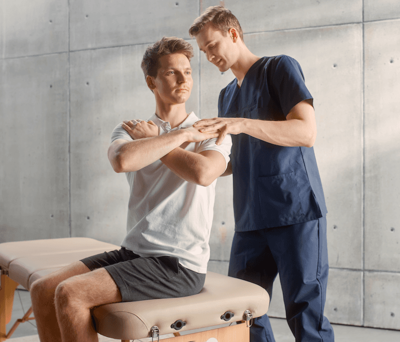 Physical therapist working with client