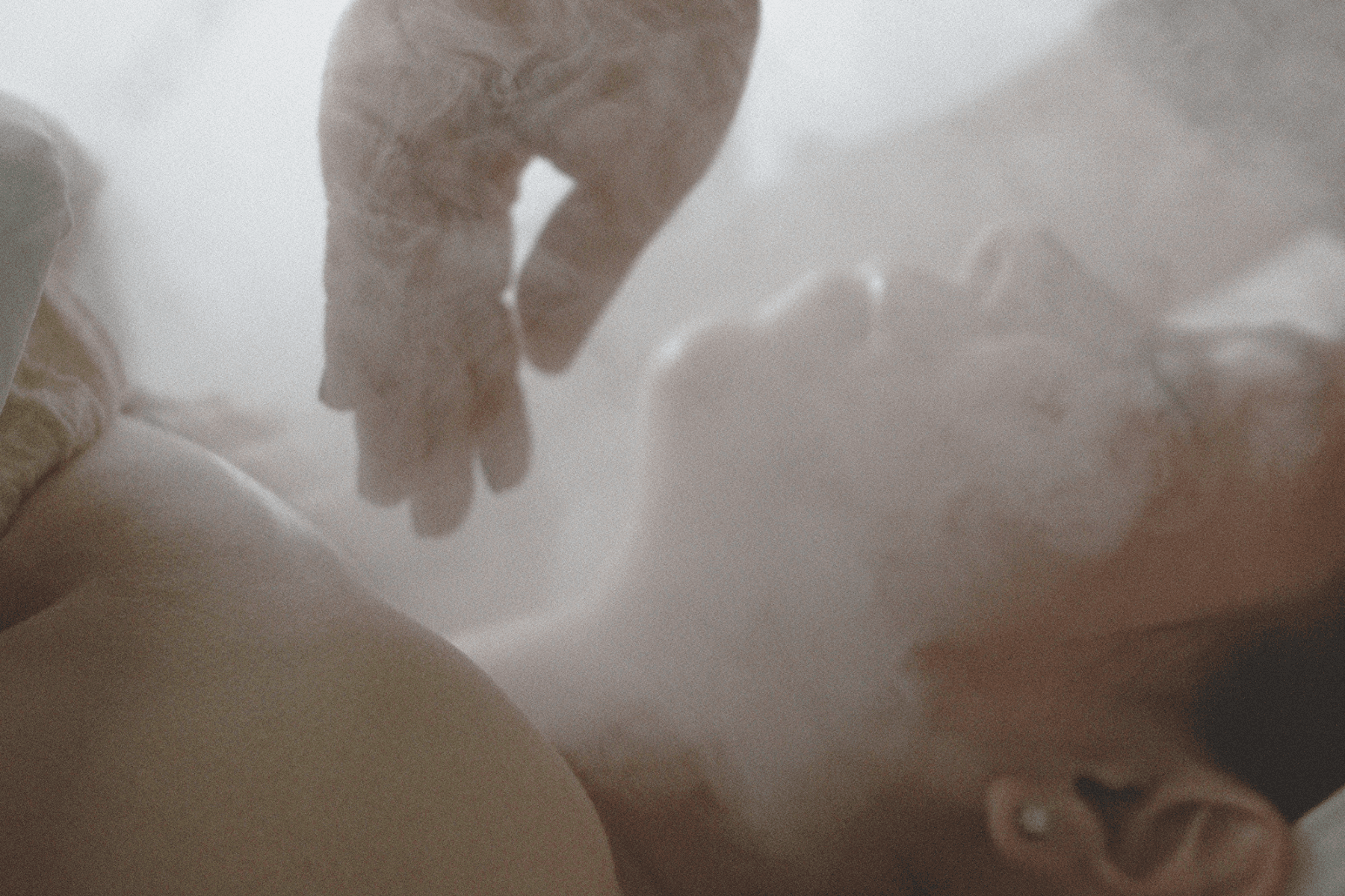 Woman receiving head spa treatment with steam and hands