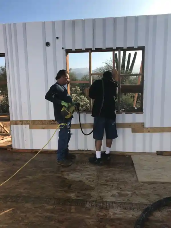 Two men building a wall with ICF