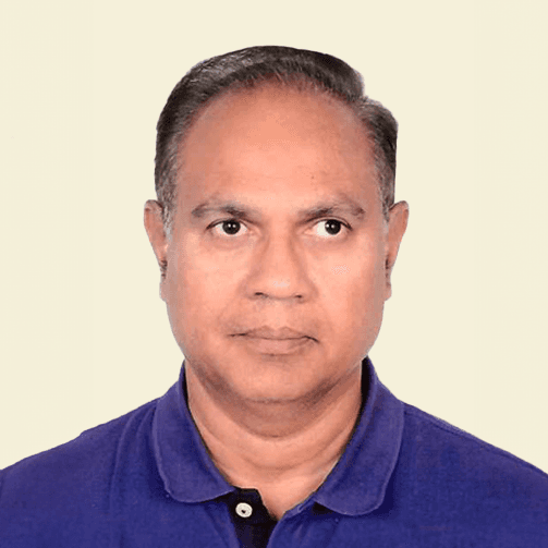 Man with arms crossed in modern office workspace.