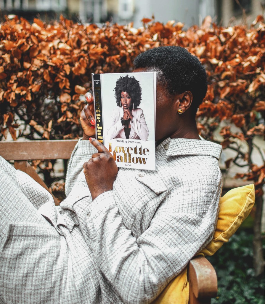 Mary sitting on a bench reading a book