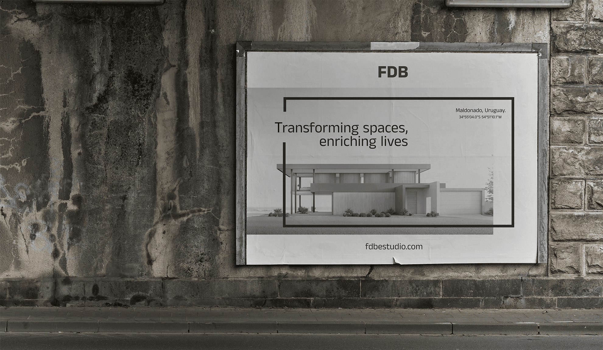 Minimalist urban poster mockup on a weathered concrete wall featuring the "FDB" brand for an architecture studio.