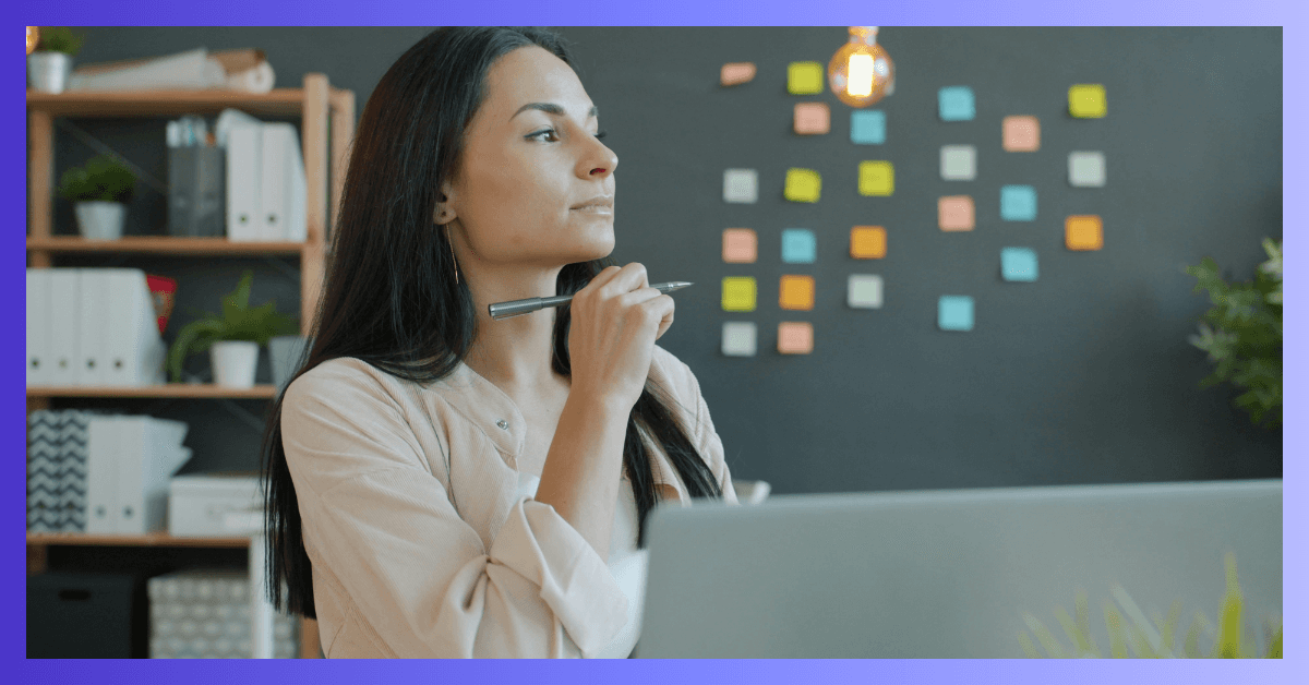 Woman thinking at her desk with a computer. Project idea and organization.