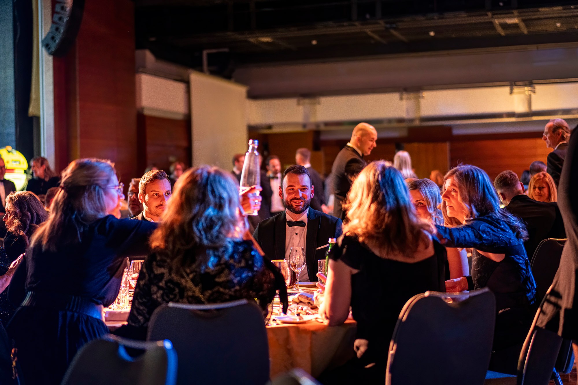 Guests in formal attire enjoying dinner and conversation during the evening gala at the CWS Workwear sales kickoff conference in Prague.