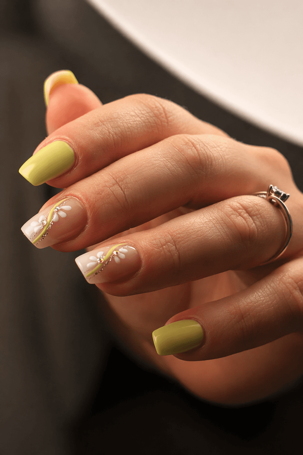 A beautifully plated dish featuring shrimp, colorful vegetables, and garnishes, set in a modern restaurant.