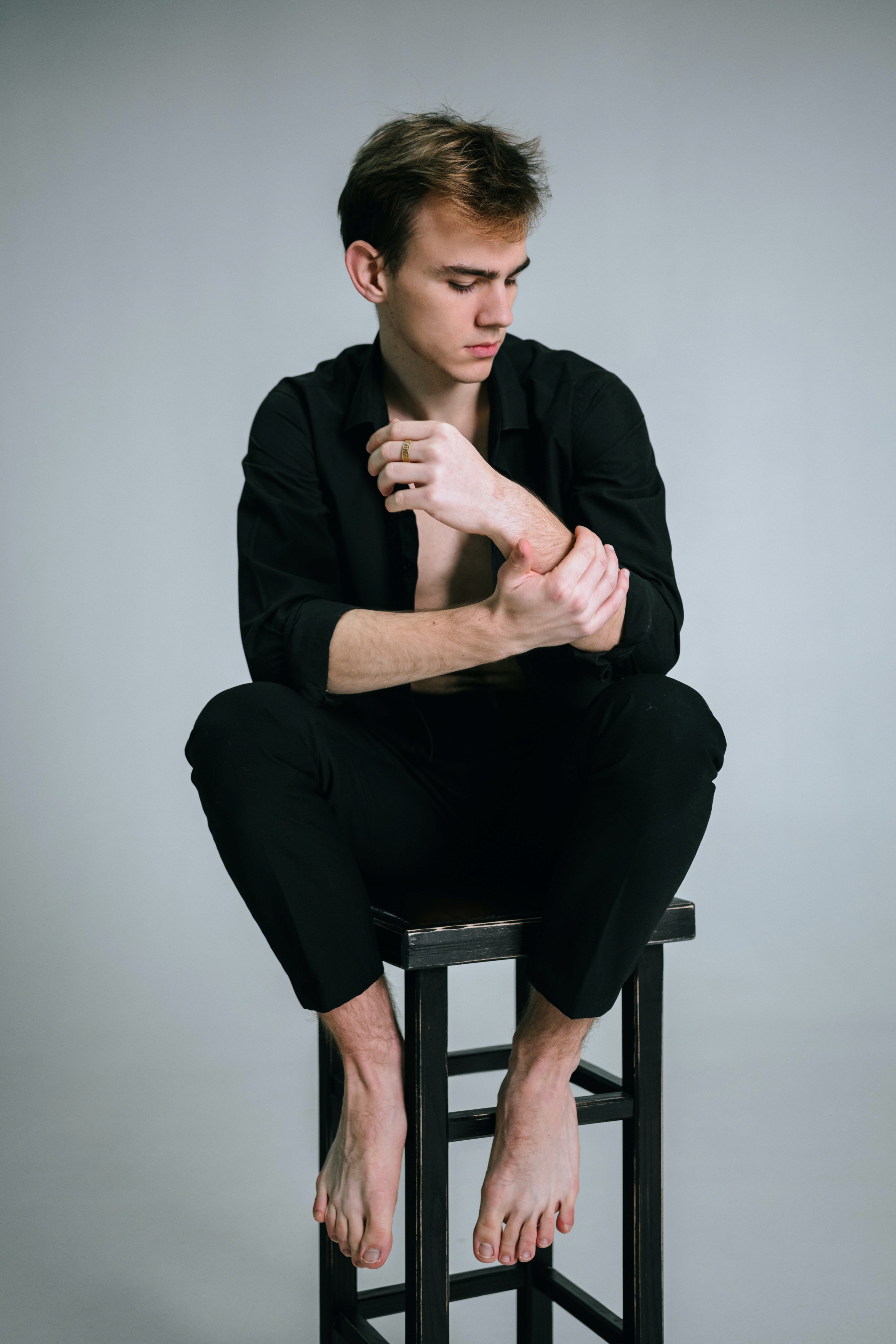 Man sitting on top of a stool