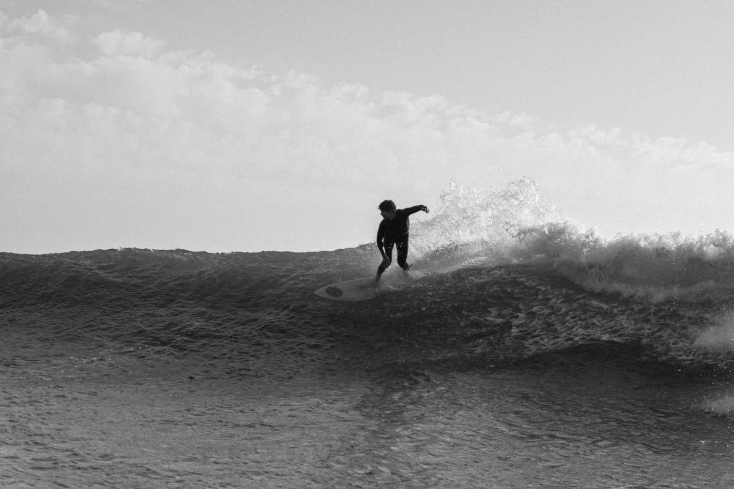 black and white pictures of a surfer