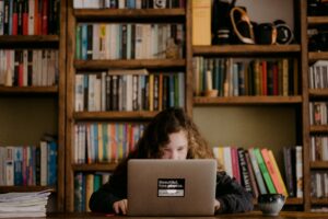 Student in library working on the laptop