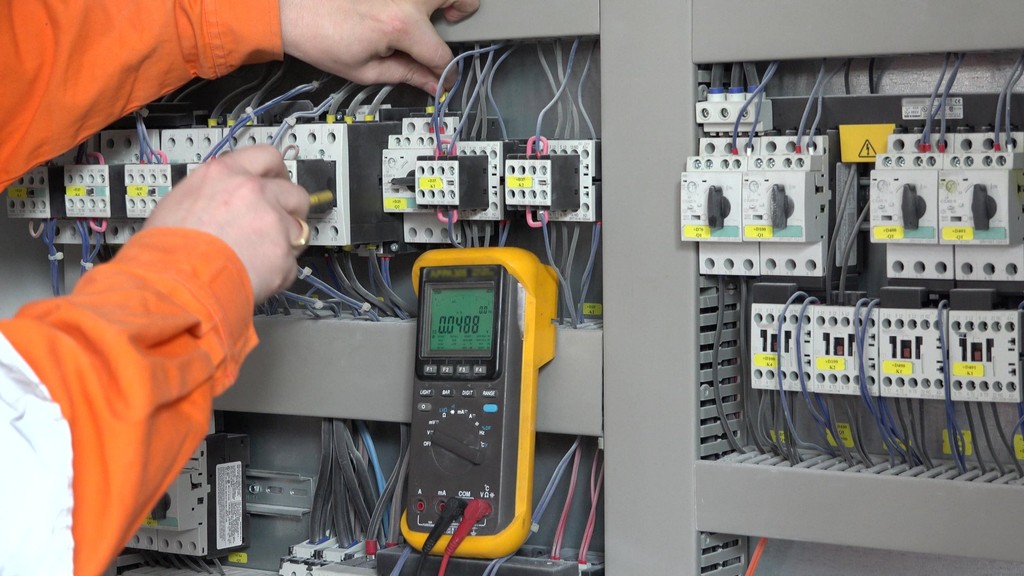 A Power2grid level 2 electrician working on a circuit box