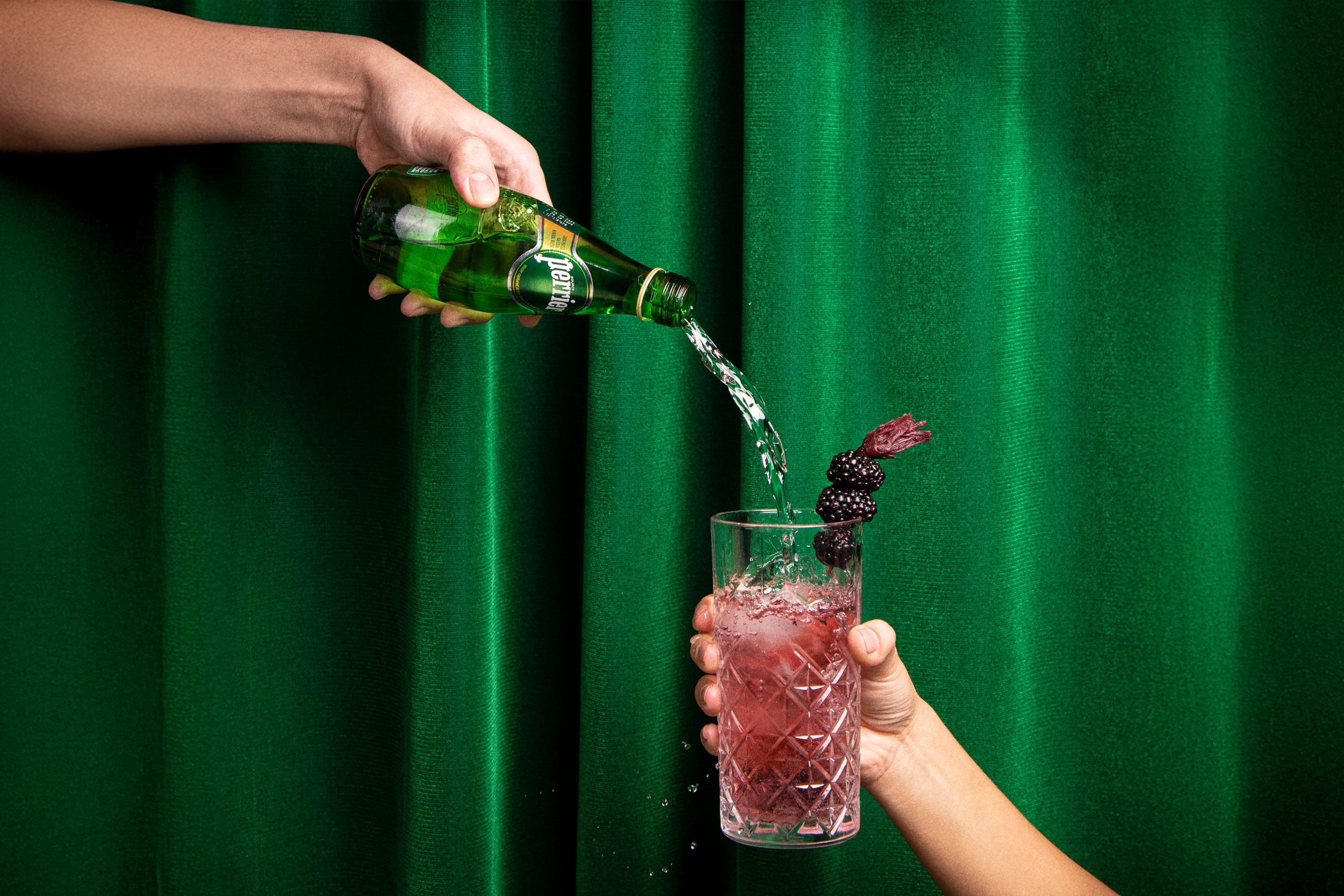 perrier bottle streaming to cocktail