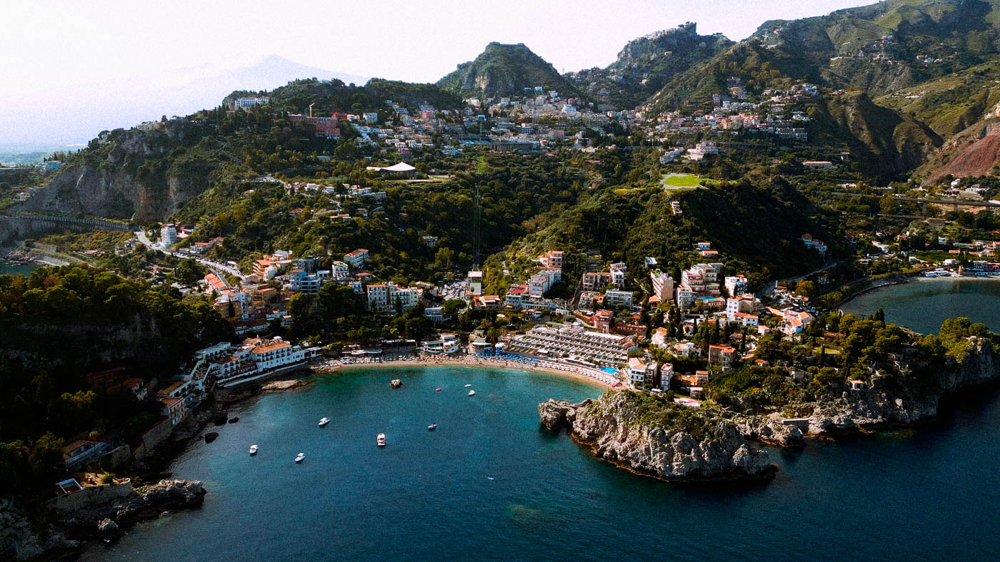 Aerial drone view of luxury wedding venue Belmond Sant'Andrea in Taormina, Sicily, at sunset.