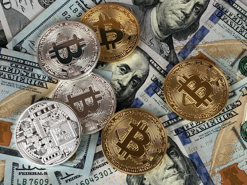 bitcoins kept on top of other currency notes