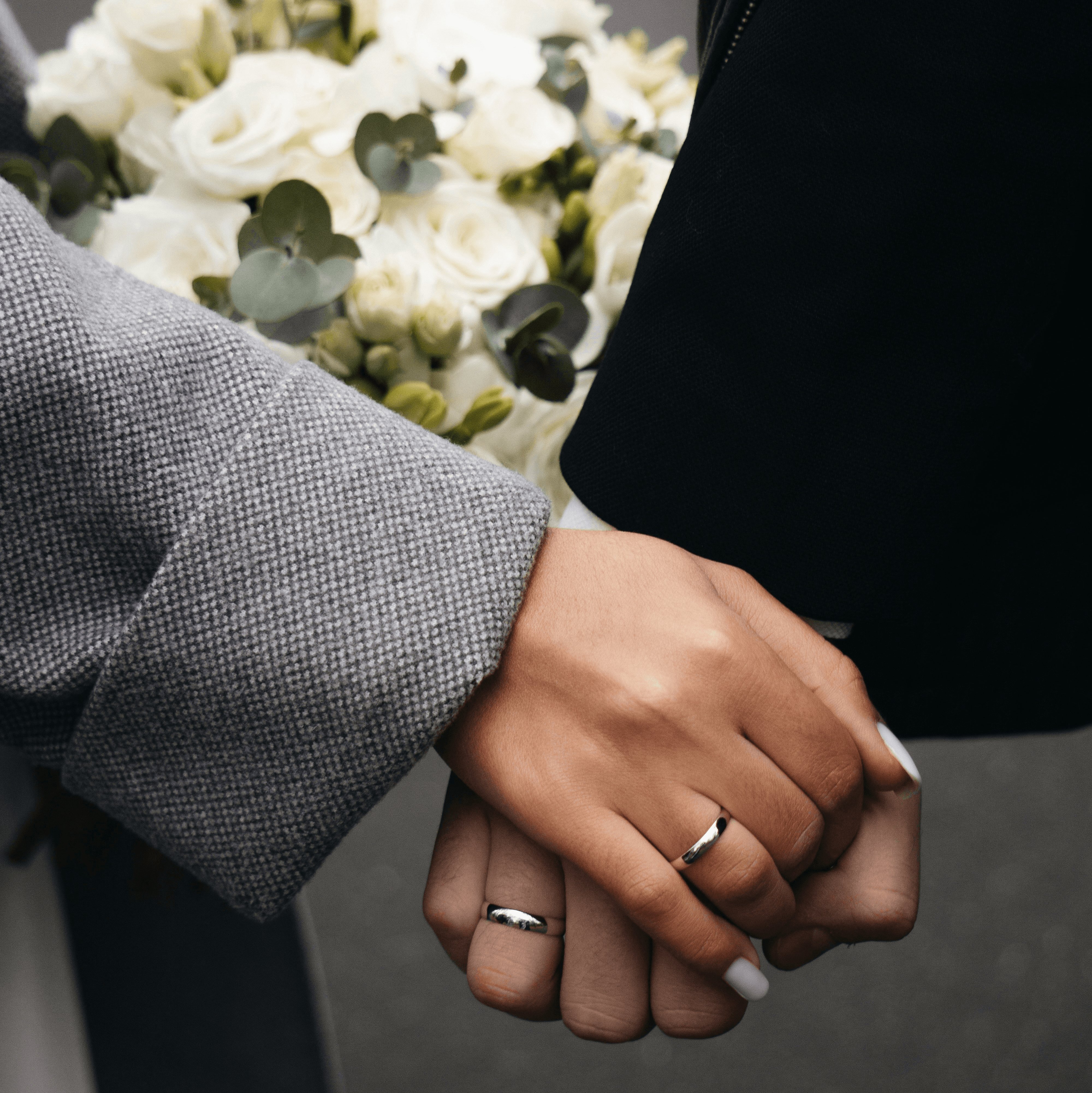 a person holding a bouquet of white flowers