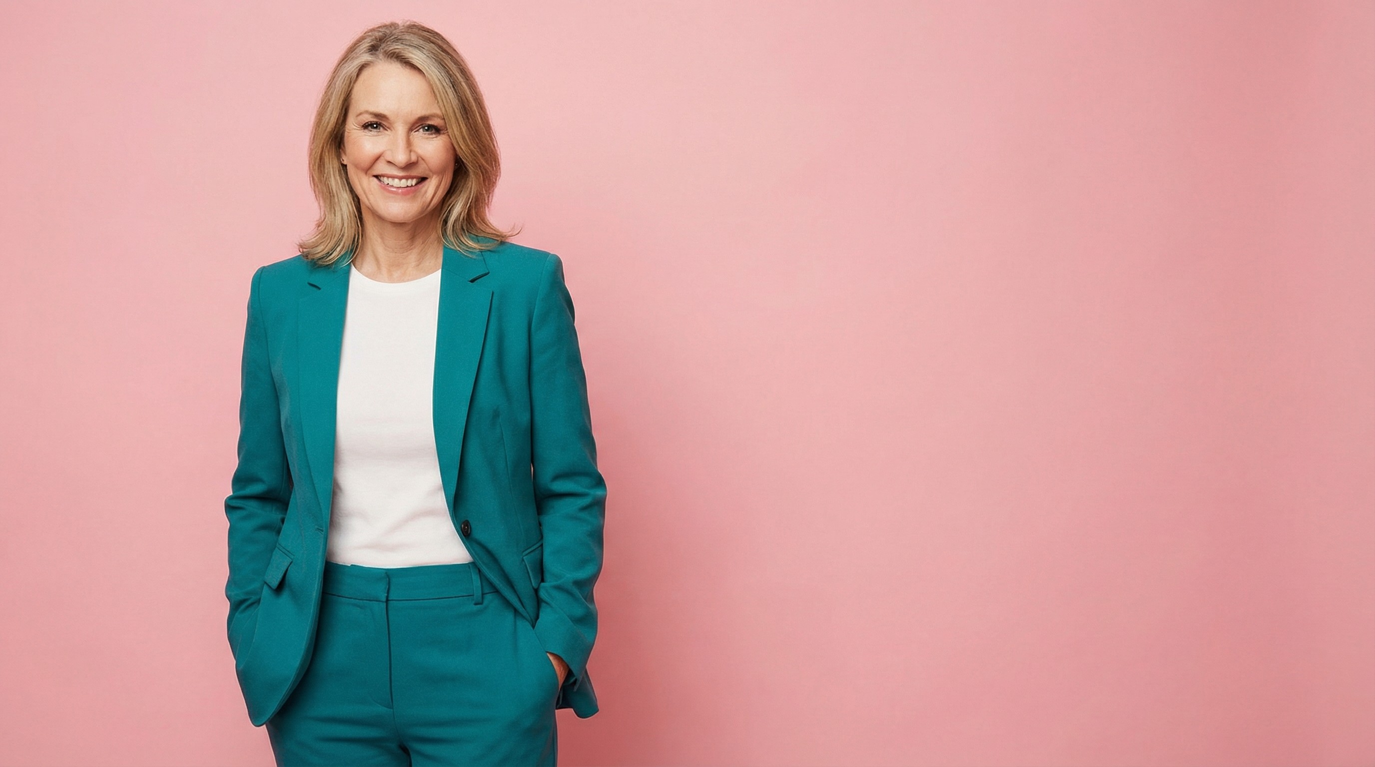 Close-up of lush, dark green leaves, some glossy and wet, against a muted background.
