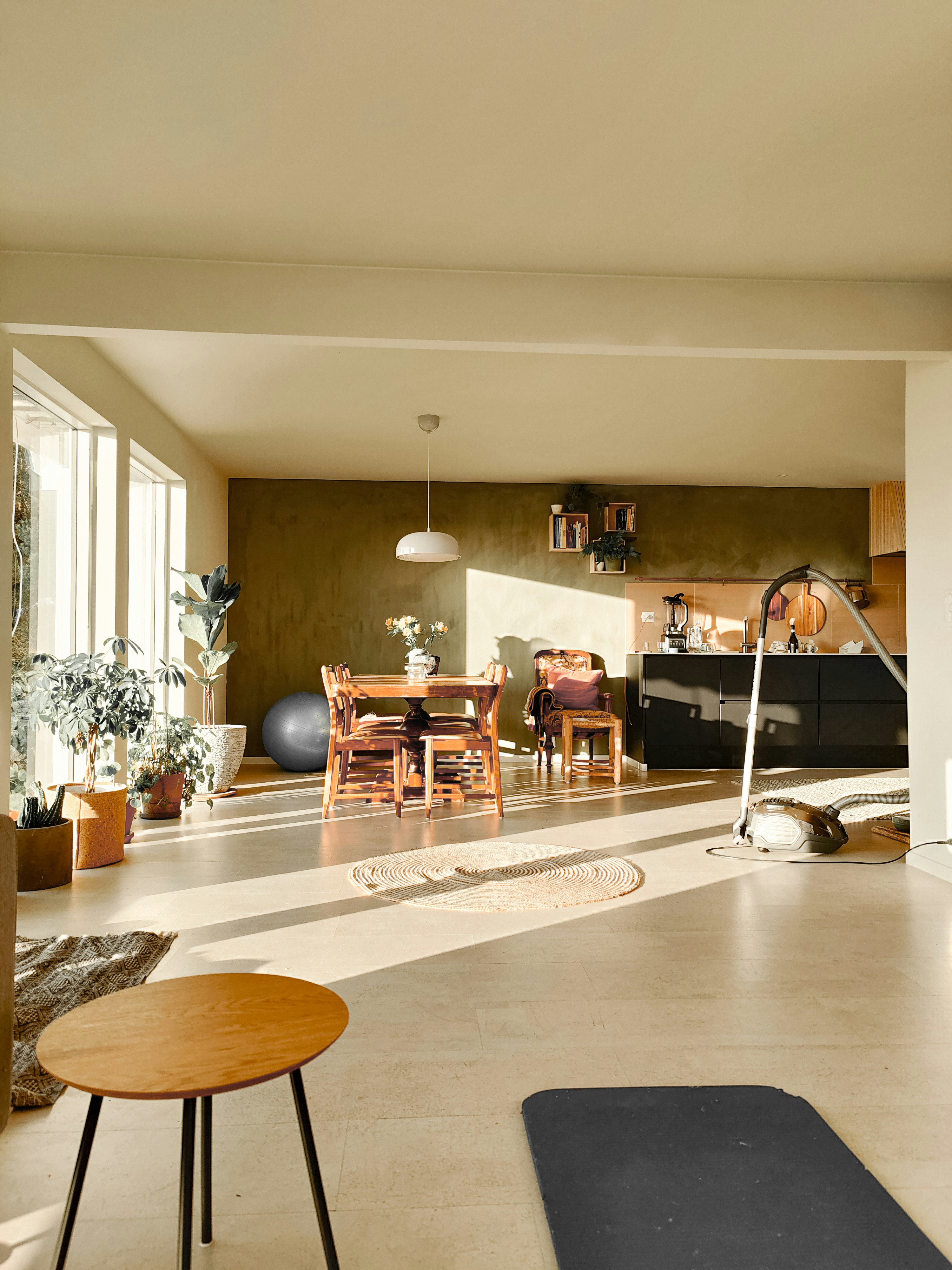 a living room filled with furniture and lots of windows