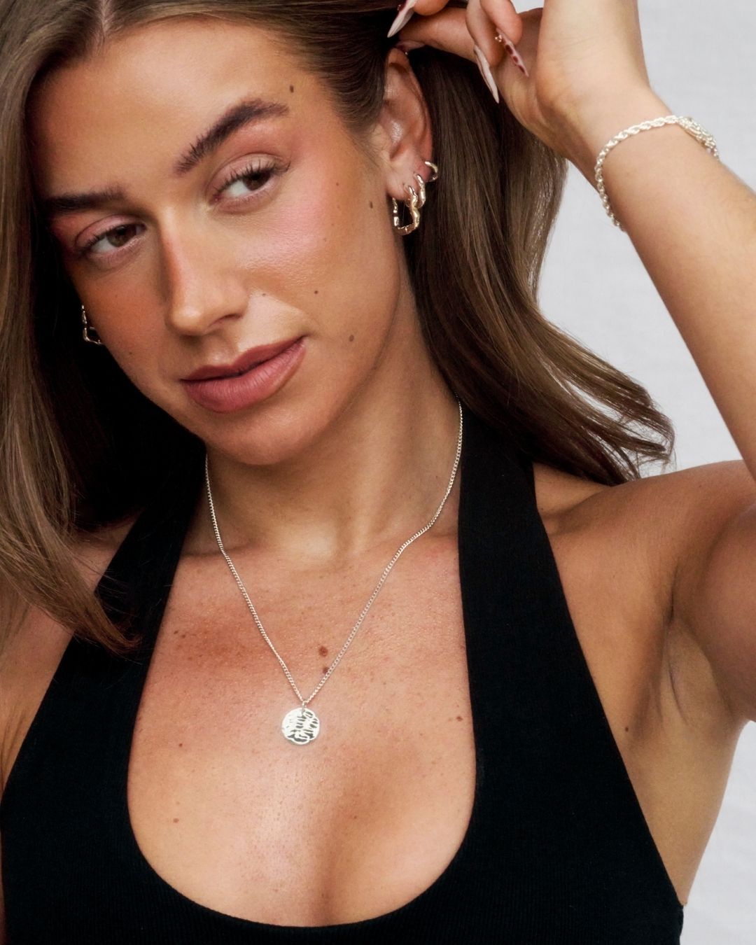 silver pendant being worn