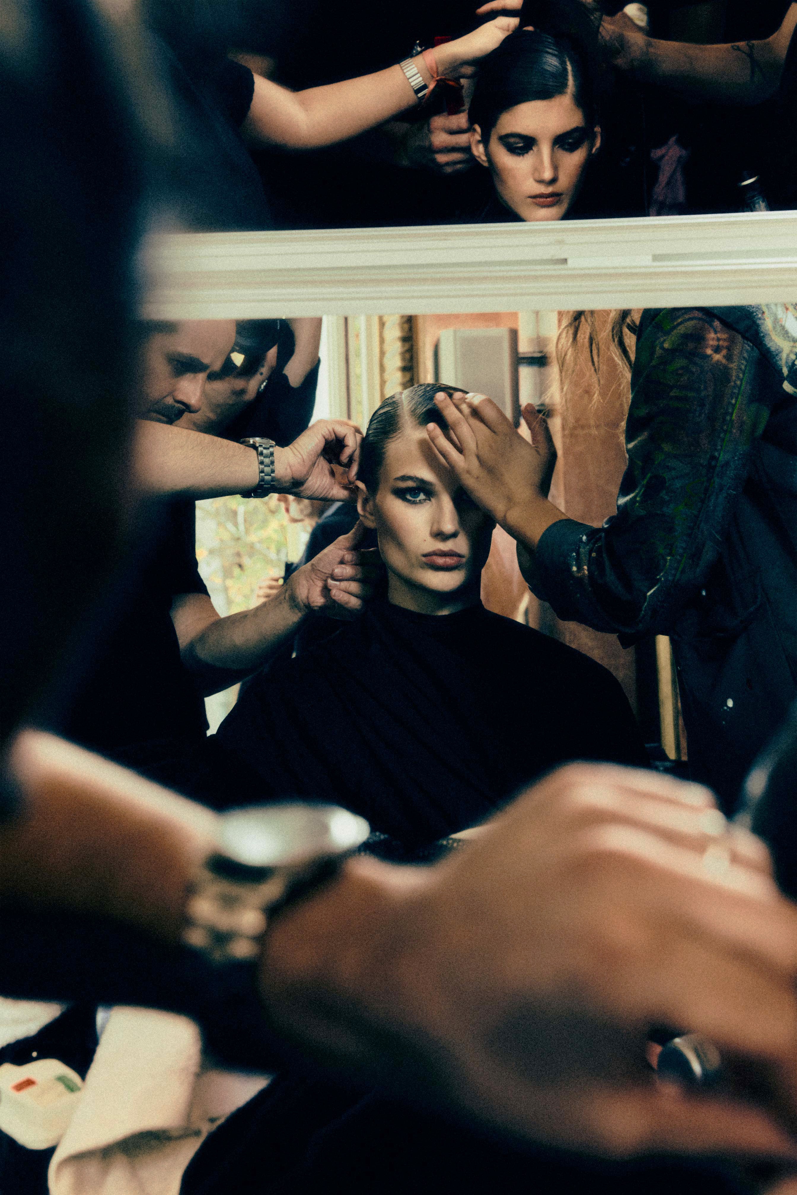 A fast black sports car races down the highway.