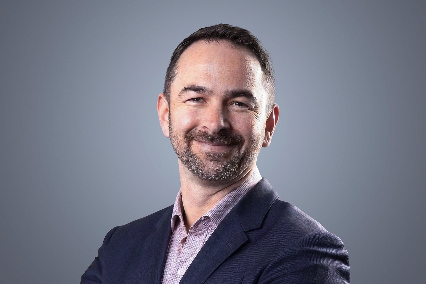Craig Potvin, SteriMax EVP, Sales and Marketing: Smiling in professional business attire against a neutral studio background.