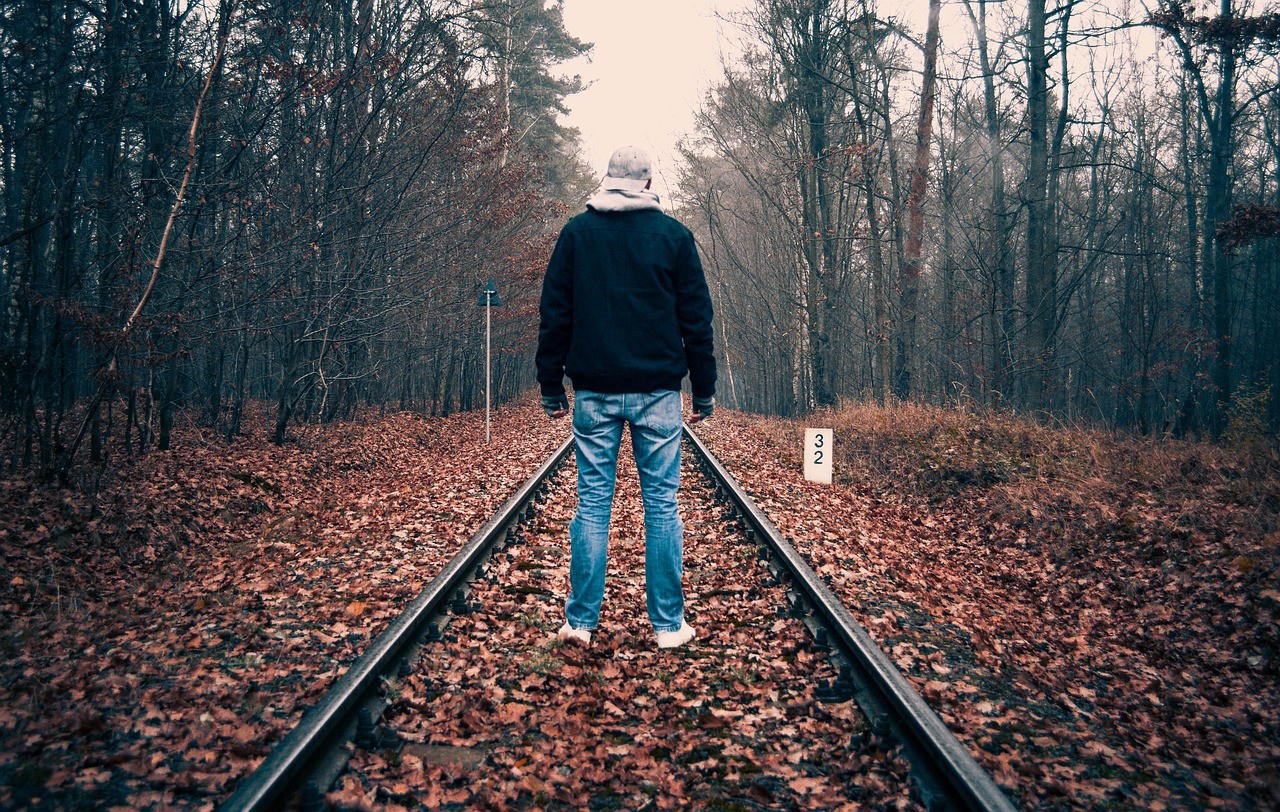 a lonely man walking on the train track, heso blog image