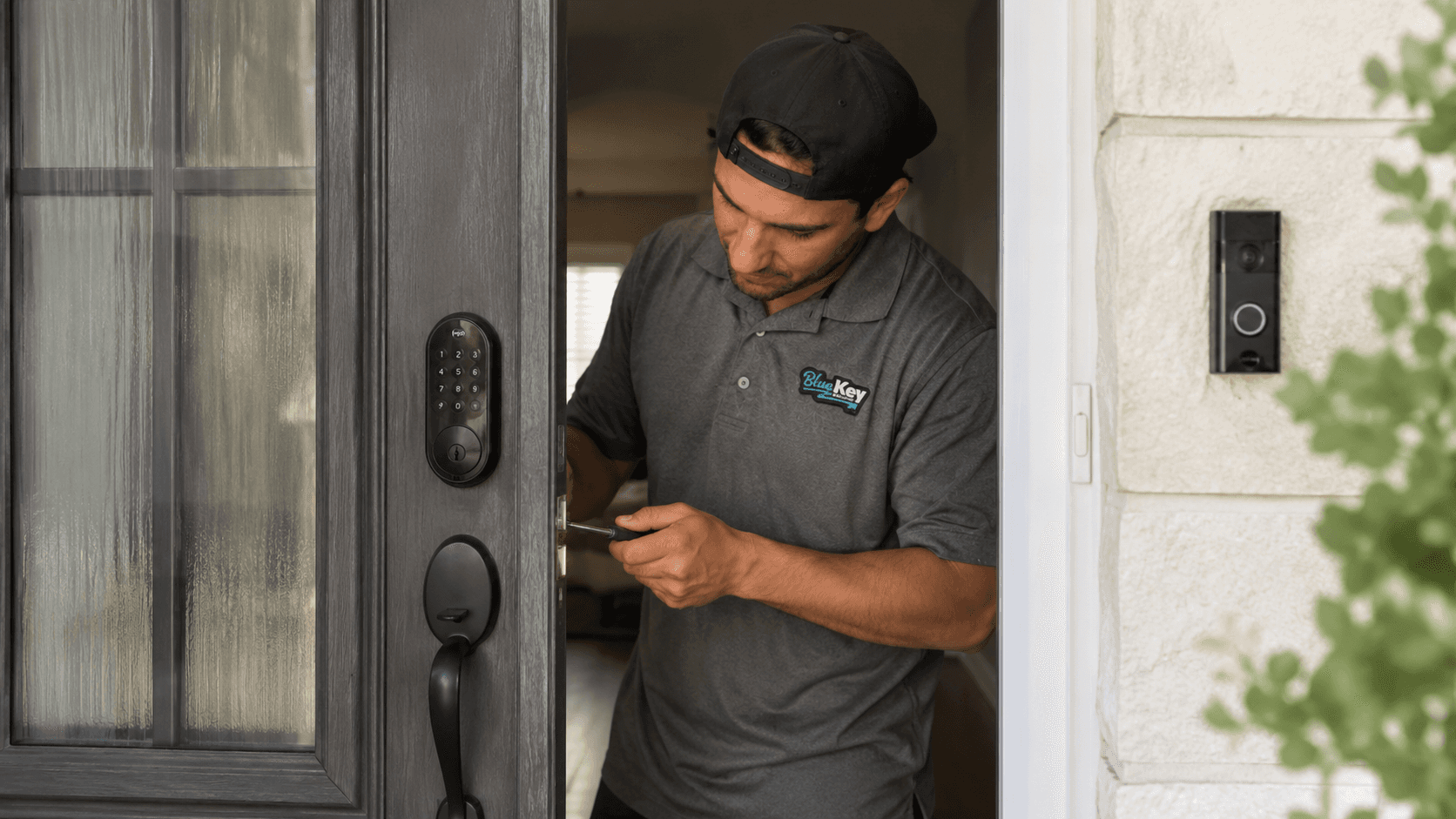Locksmith working on a residential door lock and latch