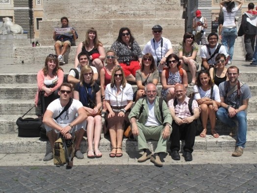 a group photo of people sitting on stairs