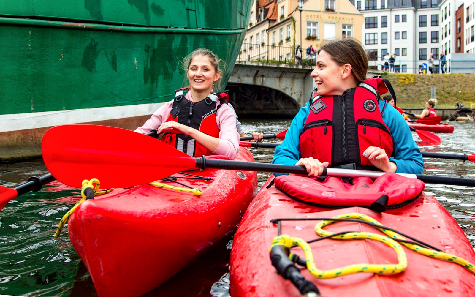 Kayakers paddling near historic buildings in Gdansk.