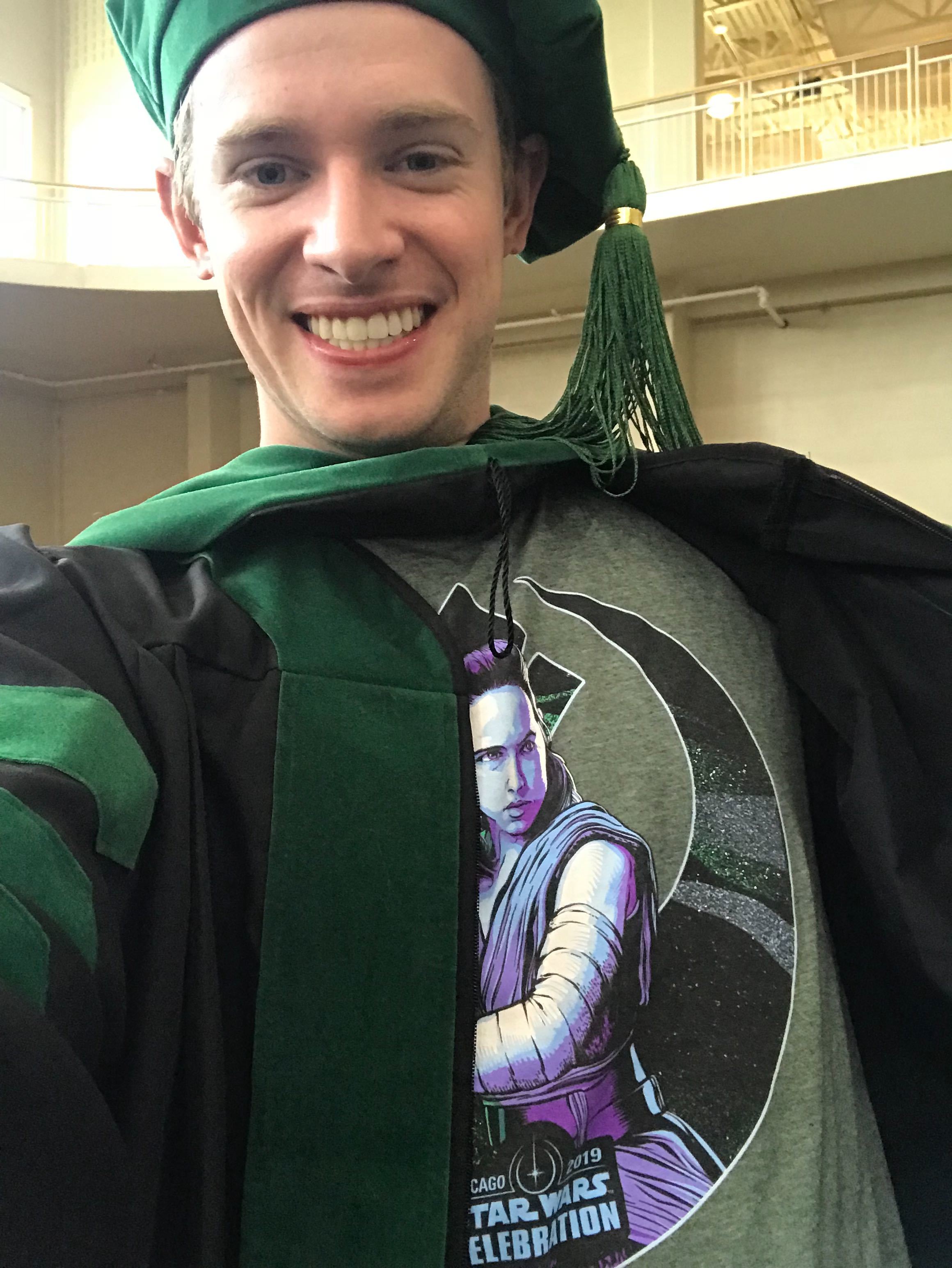 Corey with his Rey shirt graduating from medical school