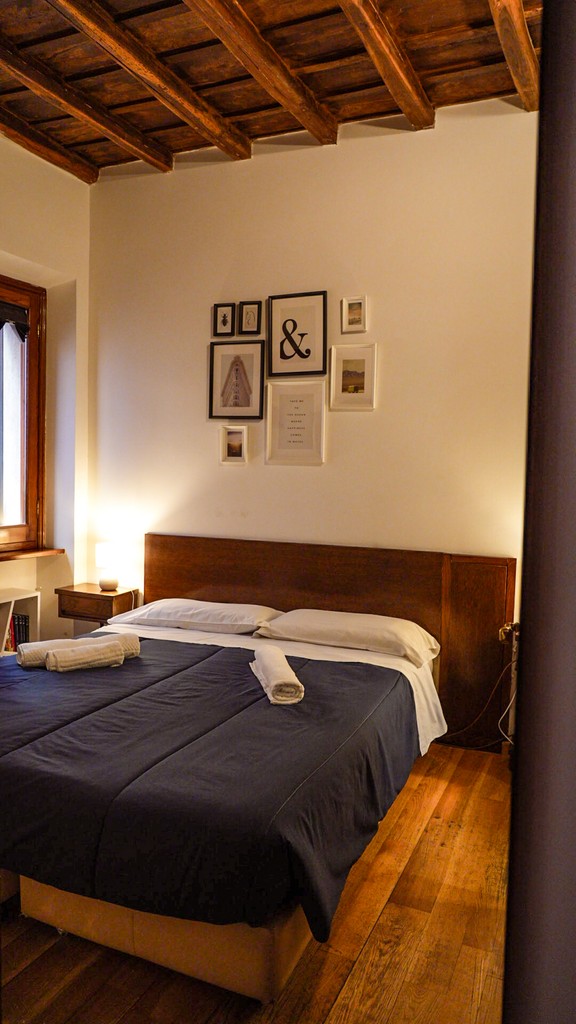Wood tables with blue vases against a mural wall
