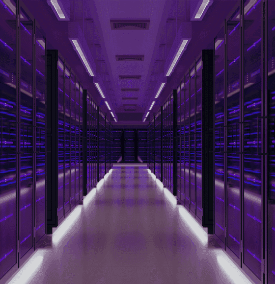 A serene outdoor seating area with two chairs, surrounded by lush greenery and a glassed-in structure.