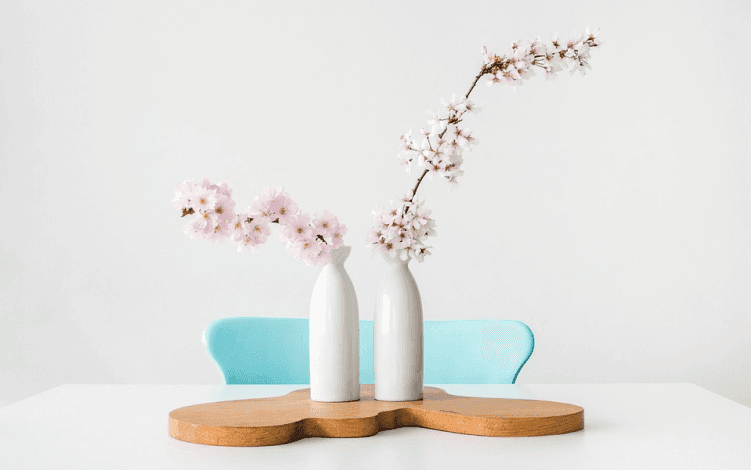 AI generated image including a chair, bases and pink blossoms