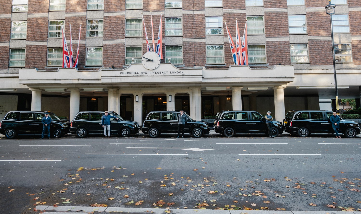 A fleet of iconic black cabs lined up in front of the Churchill Hotel in London 