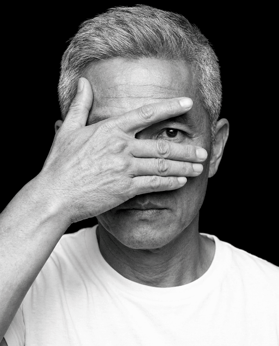Portrait, dark background flowing into a light shirt