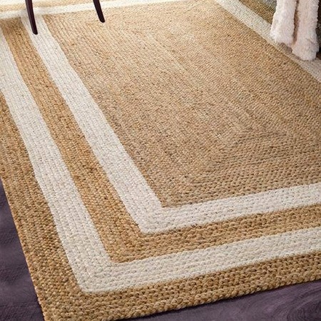 Handwoven natural jute area rug with white border frame