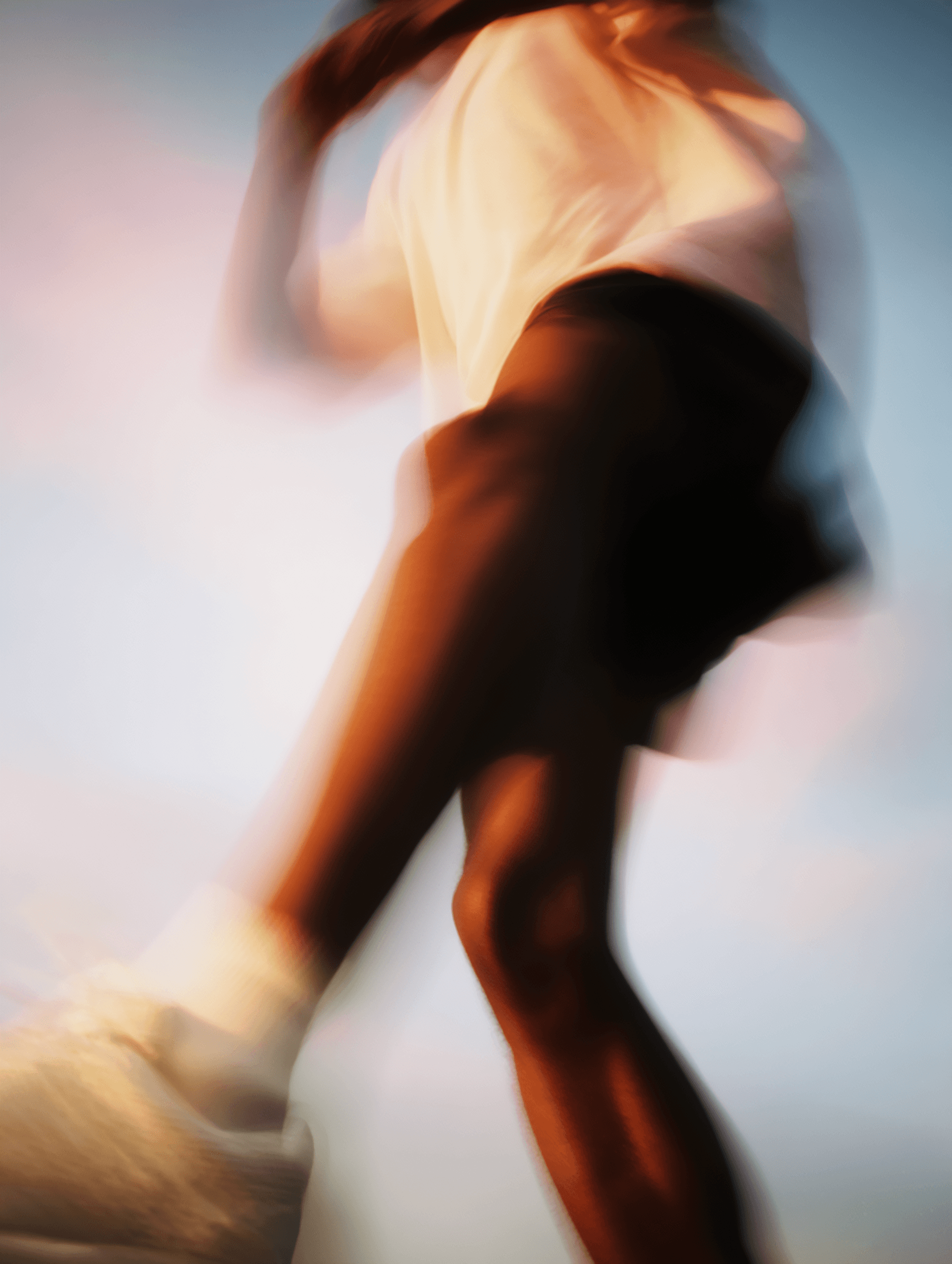 Blurred motion of a dancer with flowing movement against a soft background.