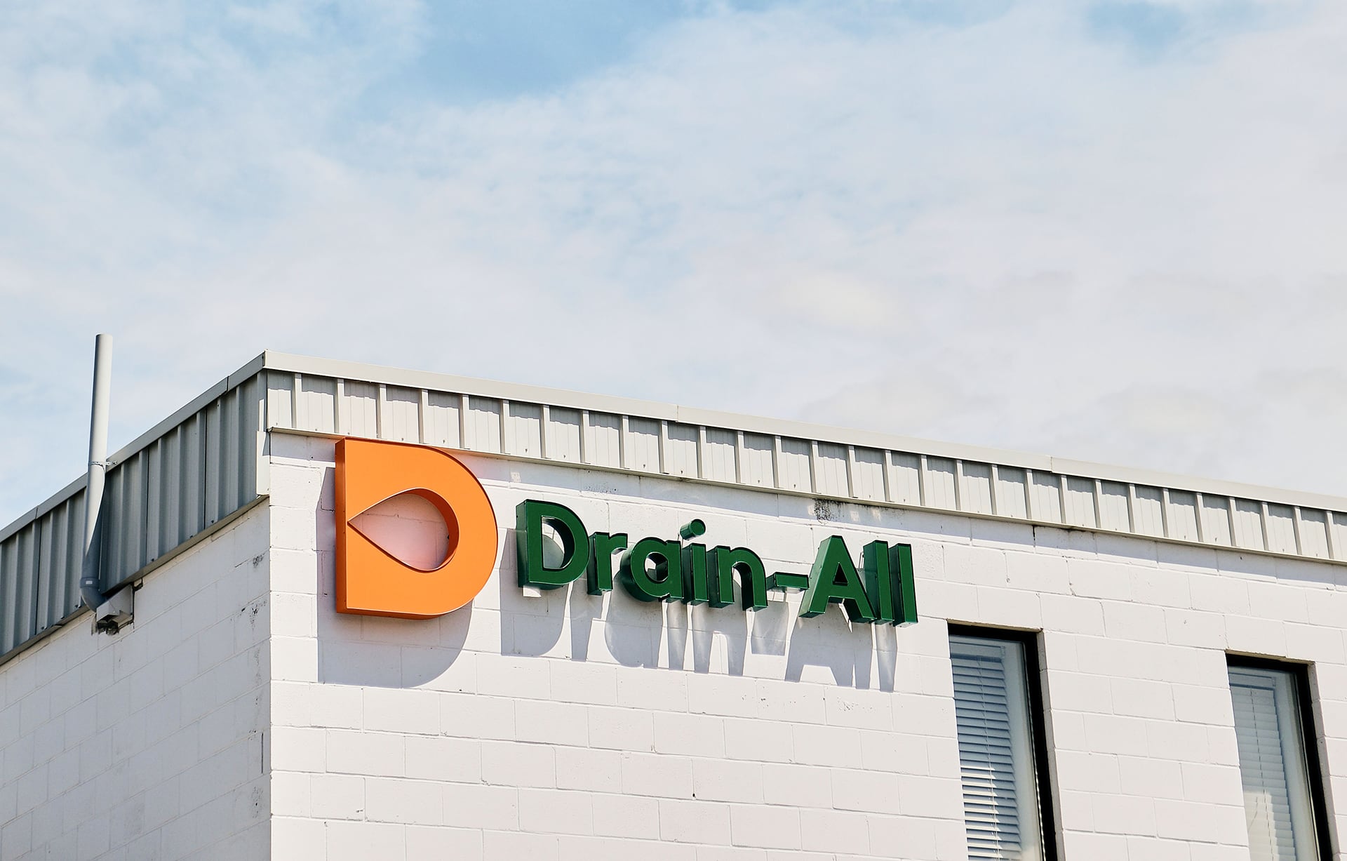 Drain-All logo sign on facility building.
