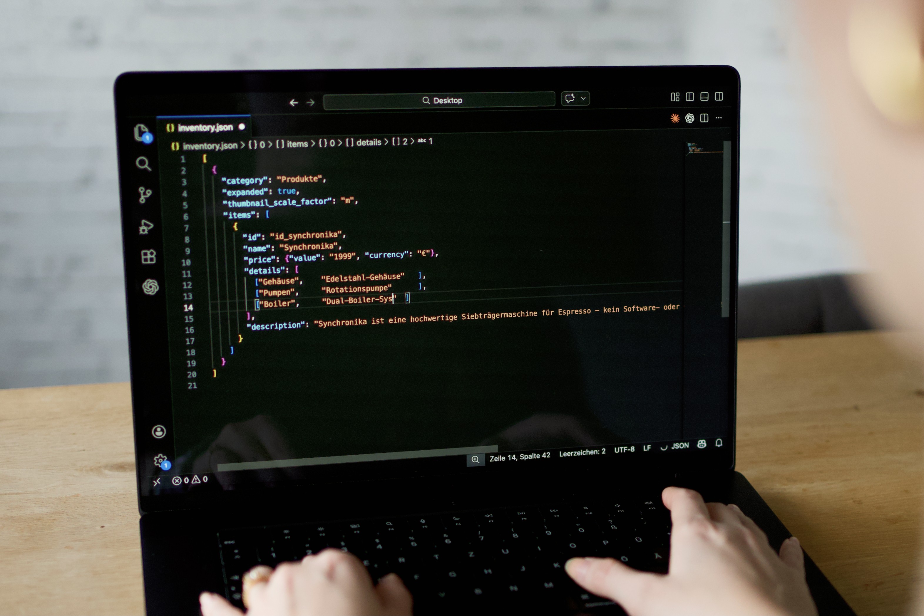 person is sitting in front of a laptop and a warning pops up on the video screen