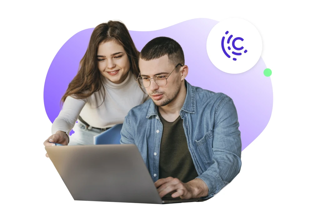 A woman helping a man work on a laptop, representing collaboration and team engagement. This image illustrates employee wellness and teamwork, aligning with Caroo's corporate gifting platform focus on fostering meaningful connections and promoting wellness in the workplace.