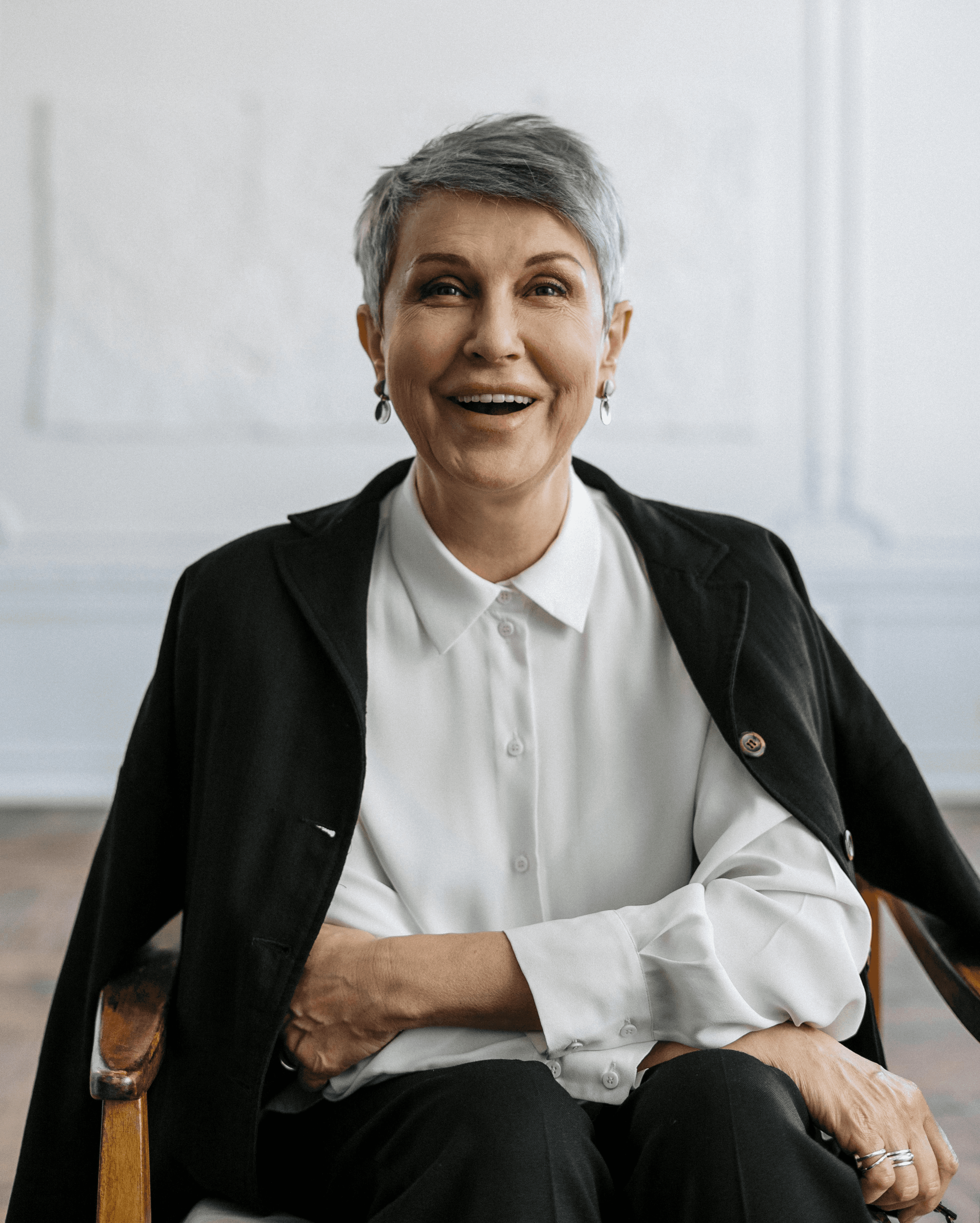 Close-up of a dark green leaf showing its textured surface and central vein against a muted background.