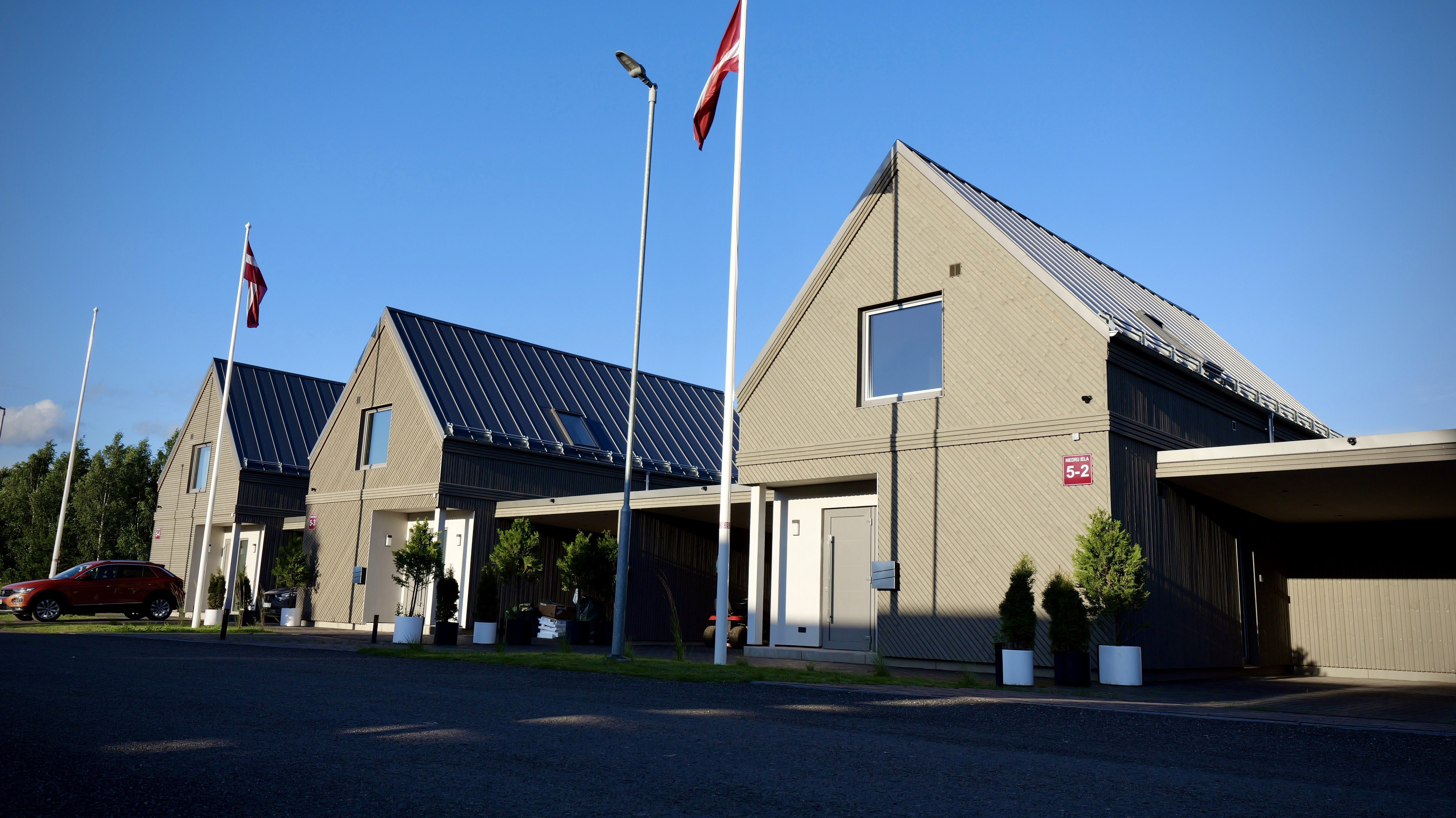 Facade of energy-efficient rental houses in Priežavoti Village, Latvia, part of Grande Build’s blockchain-based real estate project.