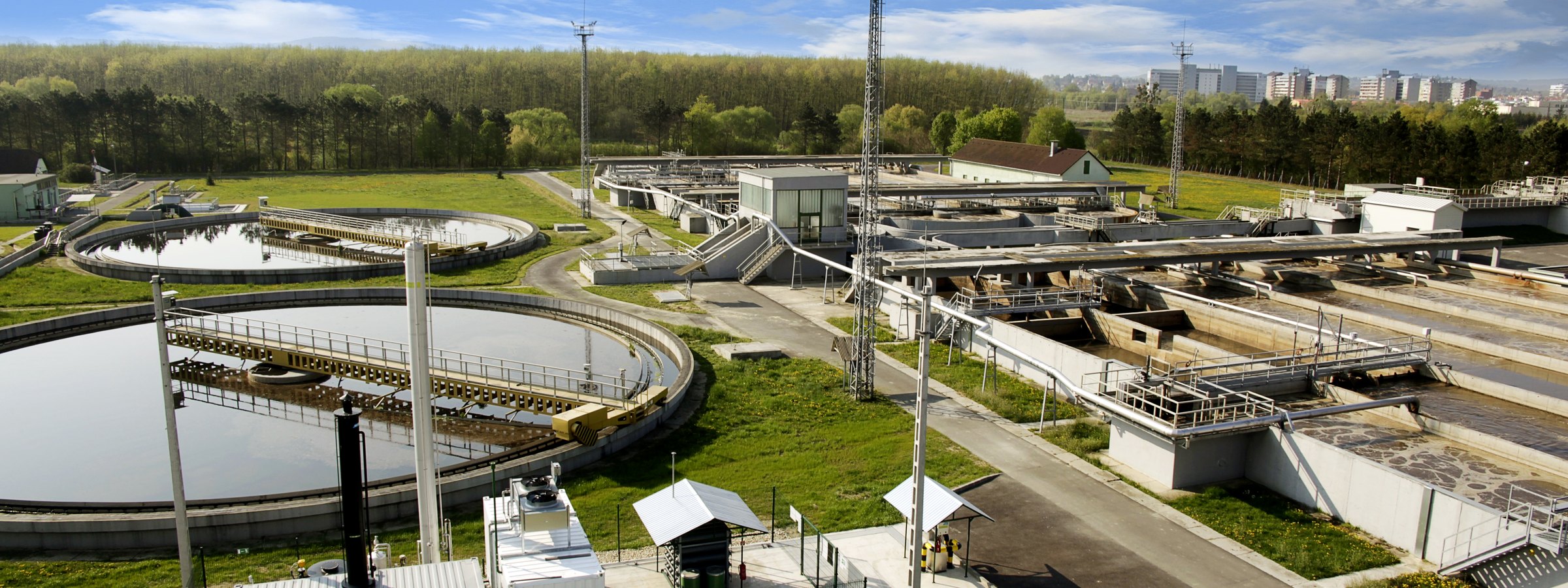 Aerial view of a municipal wastewater treatment plant with circular clarifiers