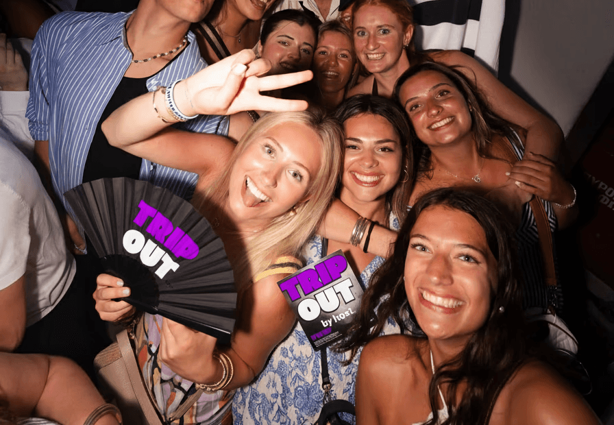Three women holding hands at outdoor event