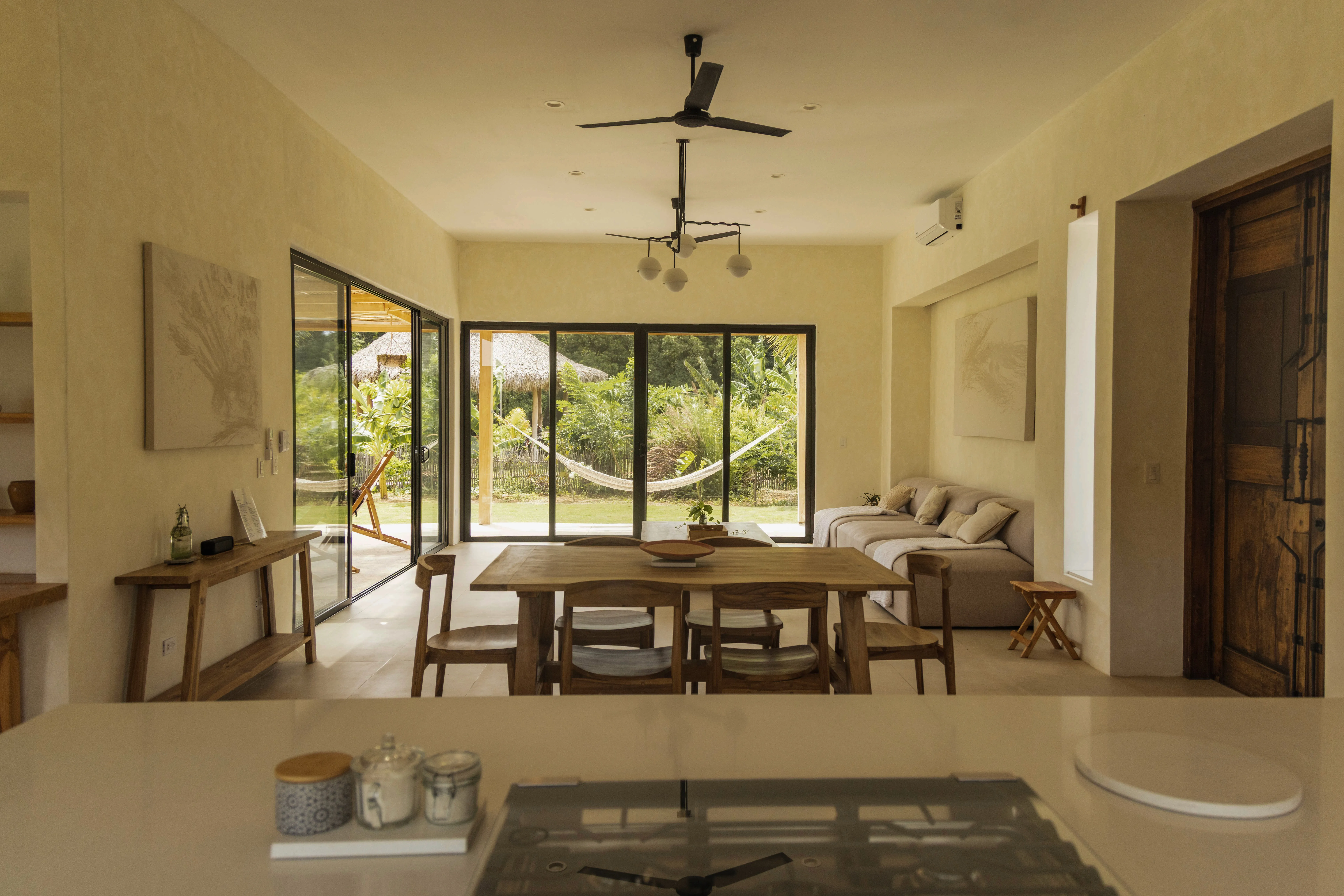 PO Houses tropical residential project by Costa Architecture, Popoyo Nicaragua — kitchen and dining room